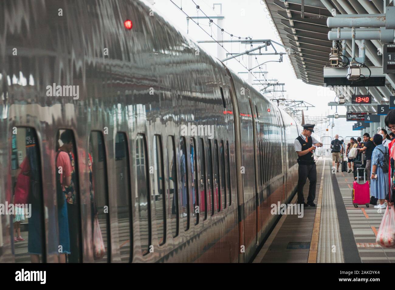 High Speed Rail Top View A Conductor Checks His Watch On The Platform As A Taiwan High Speed