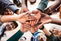 Iplayer Icon.png – Group of diverse people stacking hands in the middle Iplayer Icon.png – Group of diverse people stacking hands in the middle