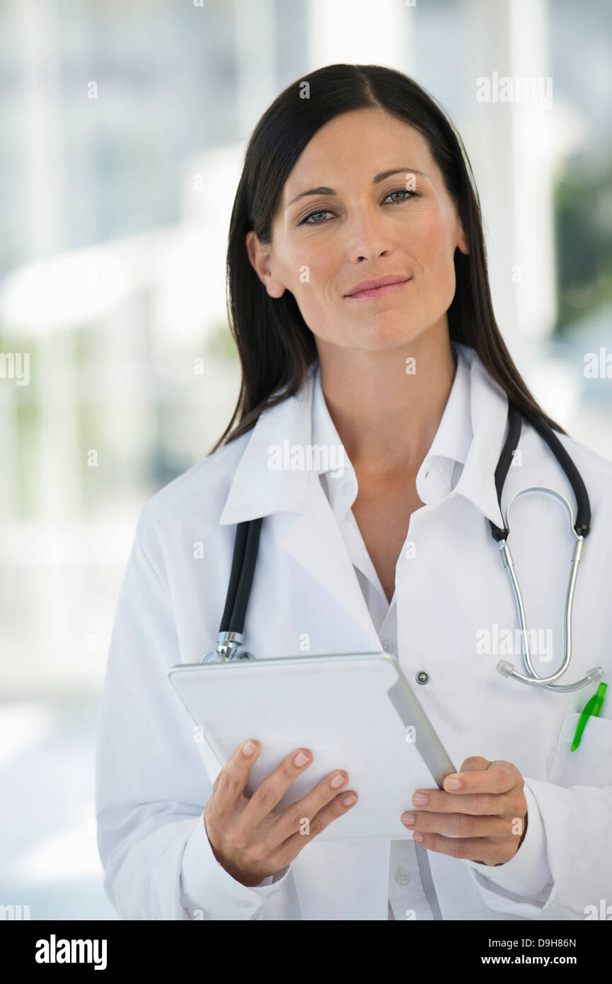 Female doctor using stethoscope hispanic hi-res stock photography and